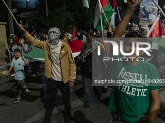 Hundreds of pro-Palestinian demonstrators march on the Israeli embassy in Athens, Greece, on October 7, 2024. (