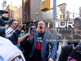 A bloodied Todd Richman stands after clashes break out where his Israeli flag is taken from him and a tambourine is thrown into his face as...