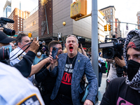 A bloodied Todd Richman stands after clashes break out where his Israeli flag is taken from him and a tambourine is thrown into his face as...