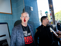 A bloodied Todd Richman stands after clashes break out where his Israeli flag is taken from him and a tambourine is thrown into his face as...