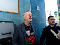 A bloodied Todd Richman stands after clashes break out where his Israeli flag is taken from him and a tambourine is thrown into his face as...