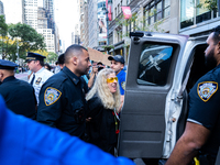 A pro-Palestinian protester is arrested during a protest commemorating the anniversary of the October 7, 2023, Hamas attack on Israel in New...