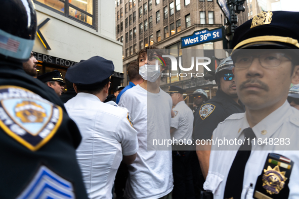 A pro-Palestinian protester is arrested during a protest commemorating the anniversary of the October 7, 2023, Hamas attack on Israel in New...