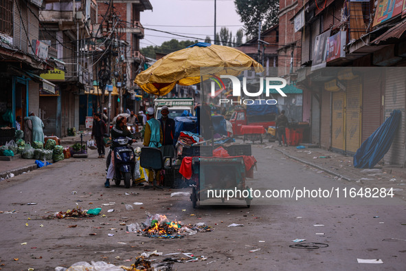 Kashmiri people walk early in the morning on the day of Assembly election results in Baramulla, Jammu and Kashmir, India, on October 8, 2024...