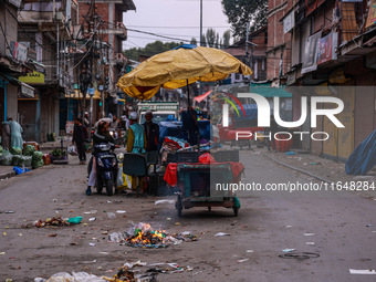 Kashmiri people walk early in the morning on the day of Assembly election results in Baramulla, Jammu and Kashmir, India, on October 8, 2024...