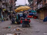 Kashmiri people walk early in the morning on the day of Assembly election results in Baramulla, Jammu and Kashmir, India, on October 8, 2024...