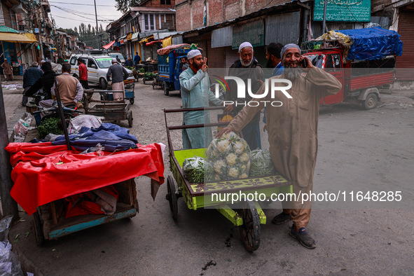 Kashmiri people talk early in the morning on the day of Assembly election results in Baramulla, Jammu and Kashmir, India, on October 8, 2024...