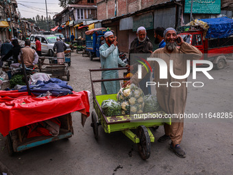 Kashmiri people talk early in the morning on the day of Assembly election results in Baramulla, Jammu and Kashmir, India, on October 8, 2024...