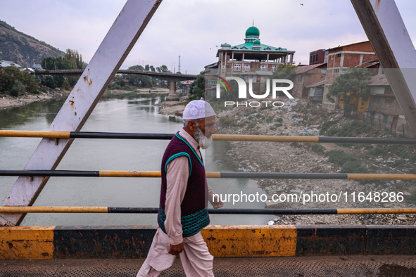 Kashmiri people walk early in the morning on the day of Assembly election results in Baramulla, Jammu and Kashmir, India, on October 8, 2024...