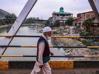 Kashmiri people walk early in the morning on the day of Assembly election results in Baramulla, Jammu and Kashmir, India, on October 8, 2024...