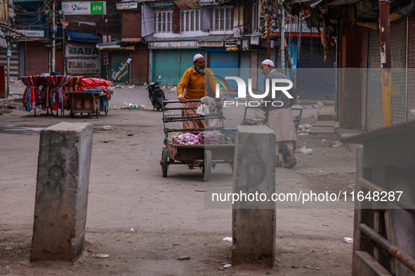 Kashmiri people walk early in the morning on the day of Assembly election results in Baramulla, Jammu and Kashmir, India, on October 8, 2024...