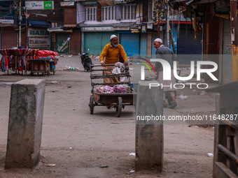 Kashmiri people walk early in the morning on the day of Assembly election results in Baramulla, Jammu and Kashmir, India, on October 8, 2024...