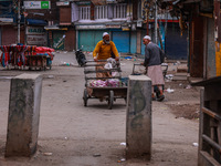 Kashmiri people walk early in the morning on the day of Assembly election results in Baramulla, Jammu and Kashmir, India, on October 8, 2024...