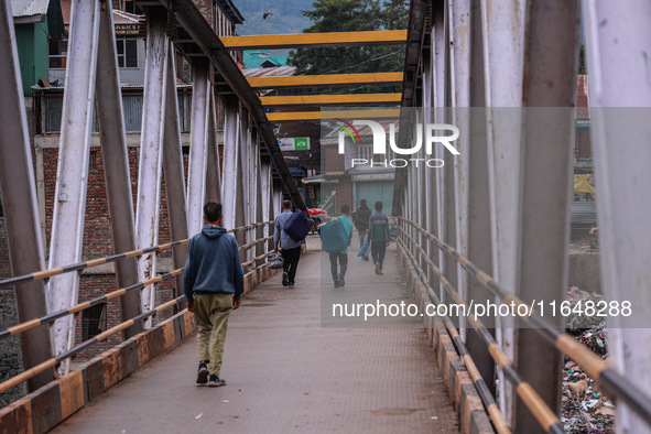 Kashmiri people walk early in the morning on the day of Assembly election results in Baramulla, Jammu and Kashmir, India, on October 8, 2024...