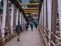 Kashmiri people walk early in the morning on the day of Assembly election results in Baramulla, Jammu and Kashmir, India, on October 8, 2024...