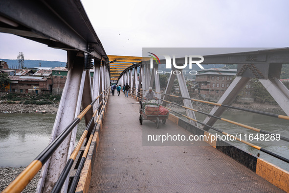 Kashmiri people walk early in the morning on the day of Assembly election results in Baramulla, Jammu and Kashmir, India, on October 8, 2024...