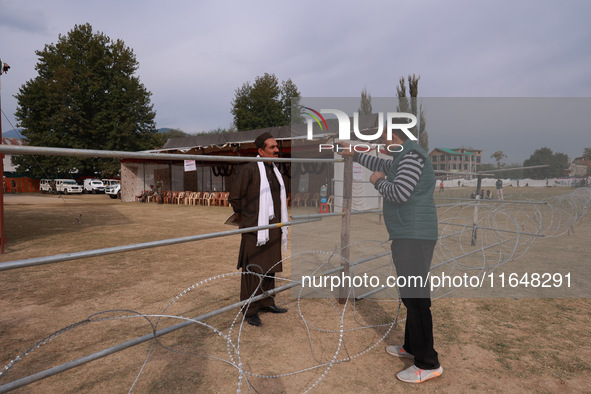 A journalist interviews an independent candidate outside the counting center for Assembly elections in Baramulla, Jammu and Kashmir, India,...