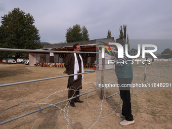 A journalist interviews an independent candidate outside the counting center for Assembly elections in Baramulla, Jammu and Kashmir, India,...