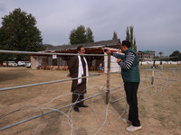 A journalist interviews an independent candidate outside the counting center for Assembly elections in Baramulla, Jammu and Kashmir, India,...