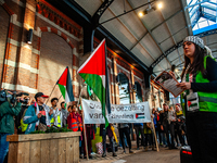 On October 7, 2024, in Nijmegen, Netherlands, hundreds of people gather at the main hall of the central train station to demand a ceasefire...