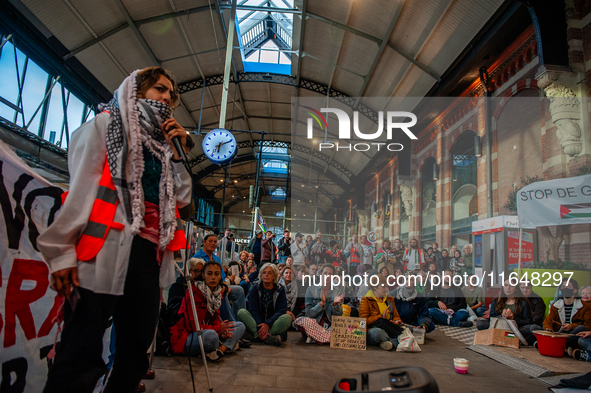 On October 7, 2024, in Nijmegen, Netherlands, hundreds of people gather at the main hall of the central train station to demand a ceasefire...