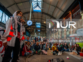 On October 7, 2024, in Nijmegen, Netherlands, hundreds of people gather at the main hall of the central train station to demand a ceasefire...