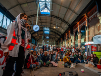 On October 7, 2024, in Nijmegen, Netherlands, hundreds of people gather at the main hall of the central train station to demand a ceasefire...