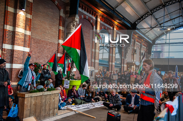 On October 7, 2024, in Nijmegen, Netherlands, hundreds of people gather at the main hall of the central train station to demand a ceasefire...