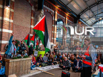 On October 7, 2024, in Nijmegen, Netherlands, hundreds of people gather at the main hall of the central train station to demand a ceasefire...