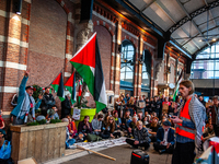 On October 7, 2024, in Nijmegen, Netherlands, hundreds of people gather at the main hall of the central train station to demand a ceasefire...