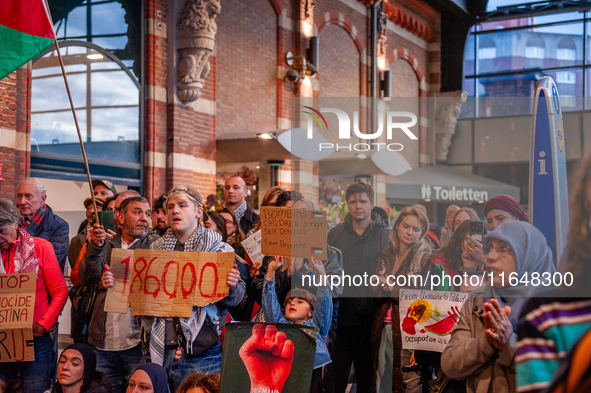 On October 7, 2024, in Nijmegen, Netherlands, hundreds of people gather at the main hall of the central train station to demand a ceasefire...