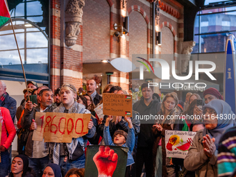 On October 7, 2024, in Nijmegen, Netherlands, hundreds of people gather at the main hall of the central train station to demand a ceasefire...