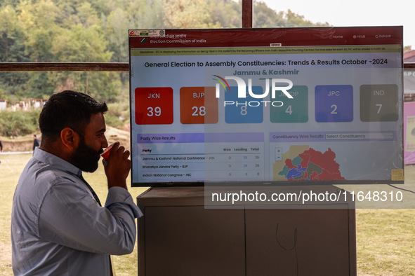 People watch the Assembly Election Results on a screen outside the counting hall in Baramulla, Jammu and Kashmir, India, on October 8, 2024 