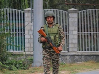 An Indian paramilitary soldier guards outside a vote counting center for the local assembly elections in Srinagar, Jammu and Kashmir, on Oct...