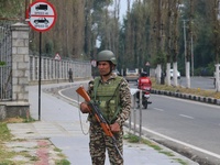 An Indian paramilitary soldier guards outside a vote counting center for the local assembly elections in Srinagar, Jammu and Kashmir, on Oct...