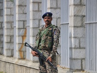 An Indian paramilitary soldier guards outside a vote counting center for the local assembly elections in Srinagar, Jammu and Kashmir, on Oct...