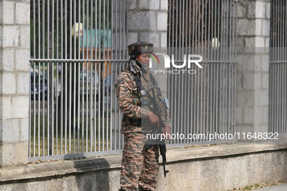 An Indian paramilitary soldier guards outside a vote counting center for the local assembly elections in Srinagar, Jammu and Kashmir, on Oct...