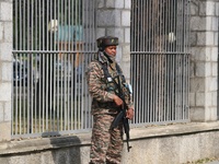 An Indian paramilitary soldier guards outside a vote counting center for the local assembly elections in Srinagar, Jammu and Kashmir, on Oct...