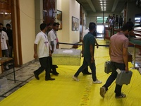 Kashmiri election officials carry a trunk loaded with electronic voting machines as the counting of votes commences for the local assembly e...