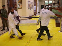 Kashmiri election officials carry a trunk loaded with electronic voting machines as the counting of votes commences for the local assembly e...