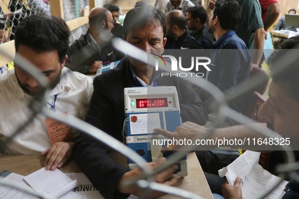 Election officials count votes for the local assembly elections at a counting center in Srinagar, Jammu and Kashmir, on October 8, 2024. 