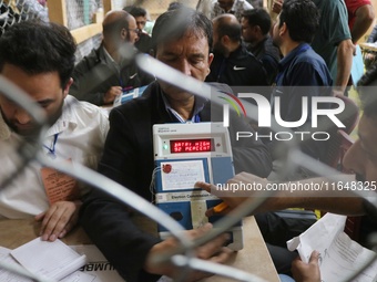 Election officials count votes for the local assembly elections at a counting center in Srinagar, Jammu and Kashmir, on October 8, 2024. (