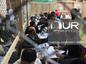 Election officials count votes for the local assembly elections at a counting center in Srinagar, Jammu and Kashmir, on October 8, 2024. (