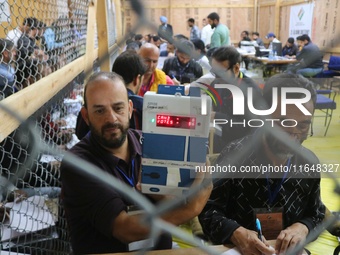 Election officials count votes for the local assembly elections at a counting center in Srinagar, Jammu and Kashmir, on October 8, 2024. (