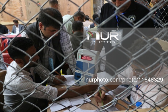 Election officials count votes for the local assembly elections at a counting center in Srinagar, Jammu and Kashmir, on October 8, 2024. 