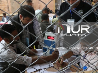 Election officials count votes for the local assembly elections at a counting center in Srinagar, Jammu and Kashmir, on October 8, 2024. (