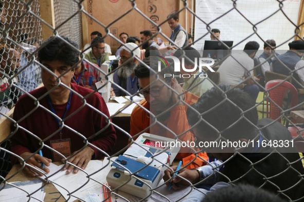 Election officials count votes for the local assembly elections at a counting center in Srinagar, Jammu and Kashmir, on October 8, 2024. 