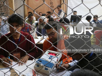 Election officials count votes for the local assembly elections at a counting center in Srinagar, Jammu and Kashmir, on October 8, 2024. (