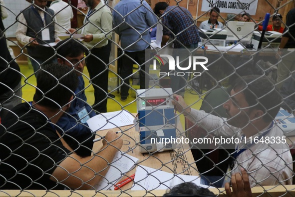 Election officials count votes for the local assembly elections at a counting center in Srinagar, Jammu and Kashmir, on October 8, 2024. 