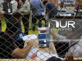 Election officials count votes for the local assembly elections at a counting center in Srinagar, Jammu and Kashmir, on October 8, 2024. (